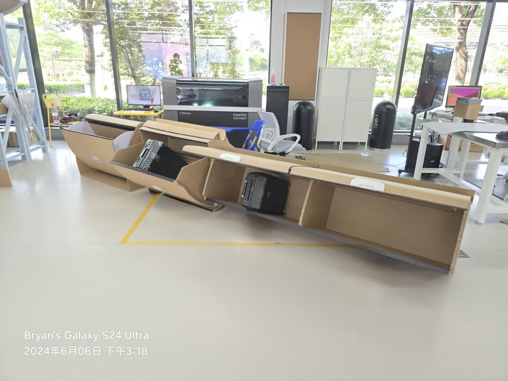 Cardboard cabin overhead-bin prototype with luggage loaded