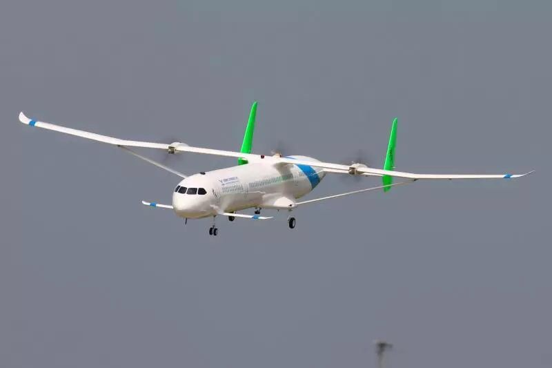 COMAC turboprop aircraft flying against a grey sky